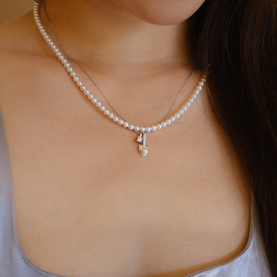 Akoya Pearl Spade Pendant Necklace detail view featuring Akoya pearl and gold-plated silver by S.Journee